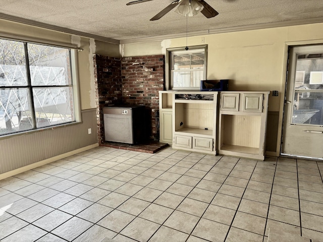 kitchen featuring ceiling fan, crown molding, and a textured ceiling