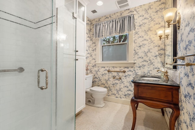 bathroom with tile patterned floors, a shower with door, vanity, and toilet