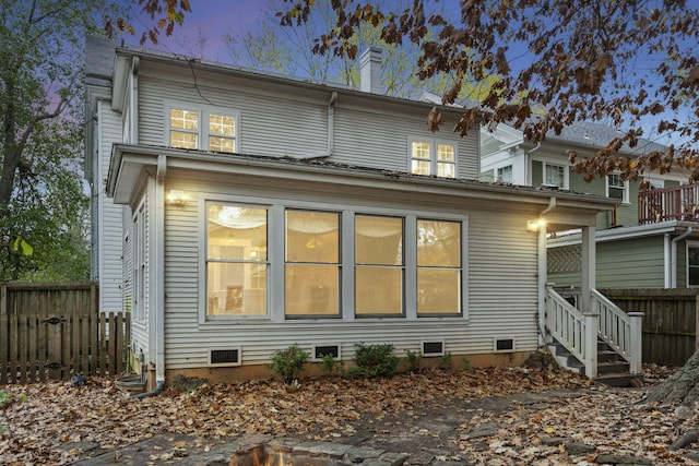 view of back house at dusk