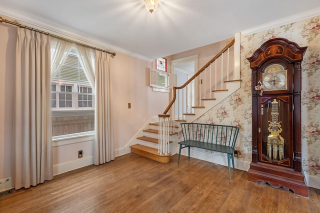 entrance foyer with crown molding, wood-type flooring, and a wall mounted air conditioner