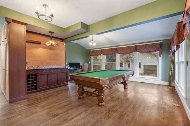 game room featuring a textured ceiling, dark hardwood / wood-style floors, vaulted ceiling, and billiards