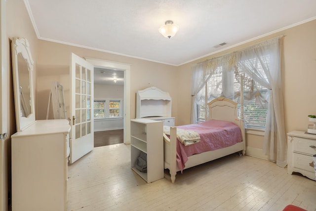 bedroom with light hardwood / wood-style flooring and ornamental molding