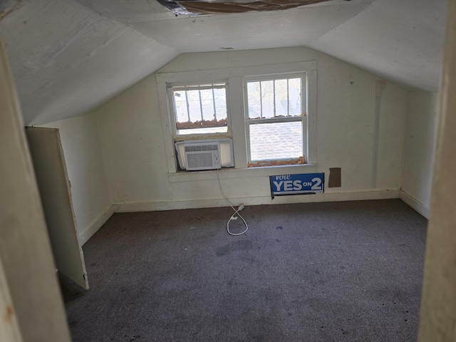 additional living space with carpet floors, cooling unit, and lofted ceiling