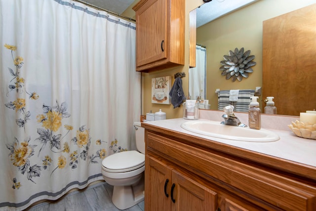 bathroom featuring hardwood / wood-style floors, vanity, and toilet