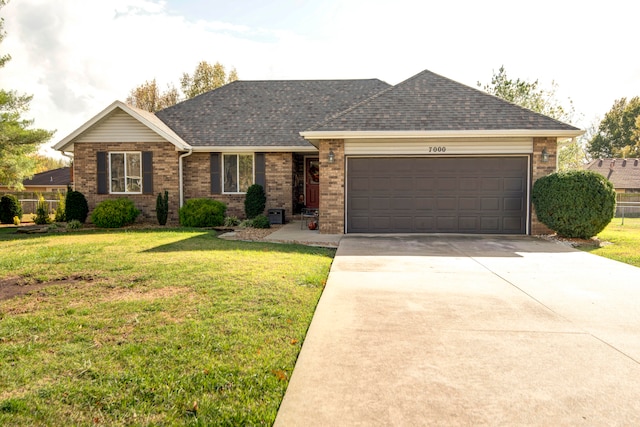 ranch-style home featuring a garage and a front lawn