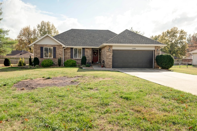 ranch-style home featuring a front yard and a garage