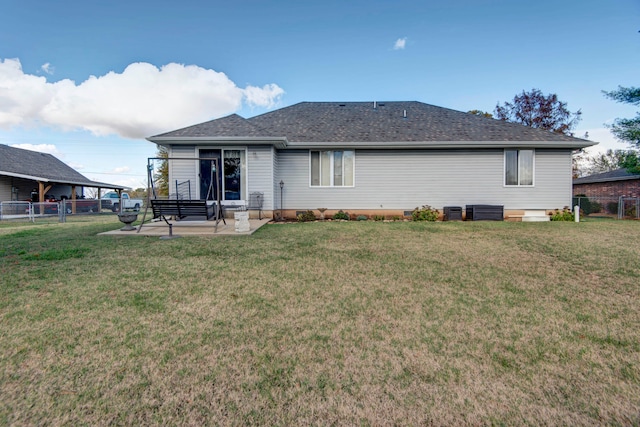 back of house with a lawn, a patio, and central AC