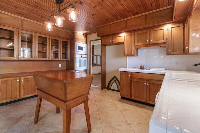 2112 Cambridge Dr, West Plains, MO 65775 - kitchen with white appliances, a sink, tile counters, wooden ceiling, and brown cabinetry