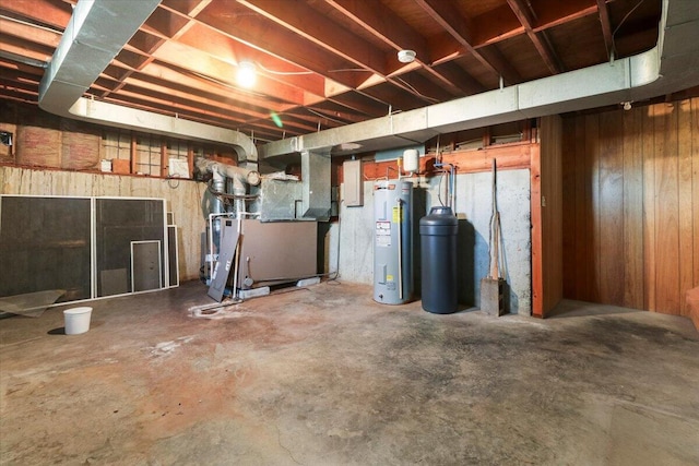 2112 Cambridge Dr, West Plains, MO 65775 - unfinished basement featuring water heater, heating unit, and wooden walls