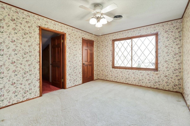 2112 Cambridge Dr, West Plains, MO 65775 - carpeted empty room featuring ornamental molding, a textured ceiling, and a ceiling fan