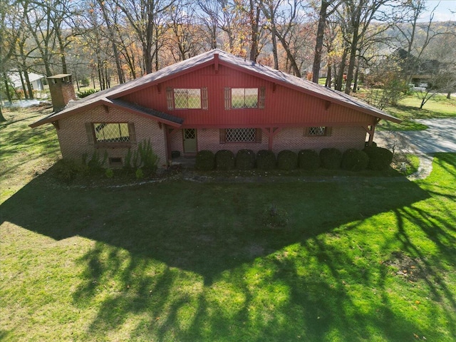 2112 Cambridge Dr, West Plains, MO 65775 - view of home's exterior featuring brick siding, a yard, and a chimney