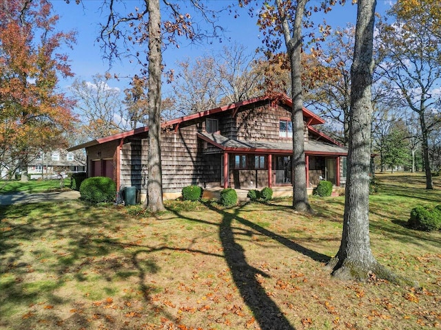 2112 Cambridge Dr, West Plains, MO 65775 - view of side of property with an attached garage and a yard