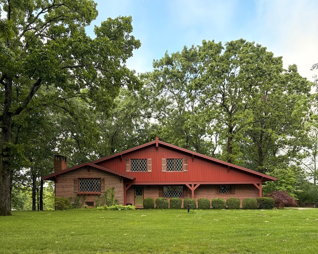 2112 Cambridge Dr, West Plains, MO 65775 - view of front of house featuring a chimney, brick siding, and a front lawn
