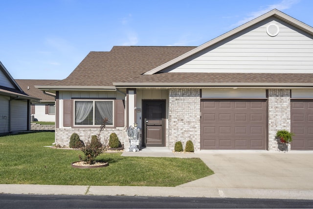 view of front of house with a front yard and a garage