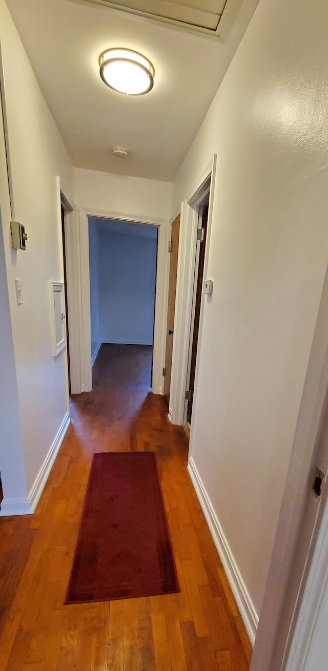 hall with dark hardwood / wood-style floors