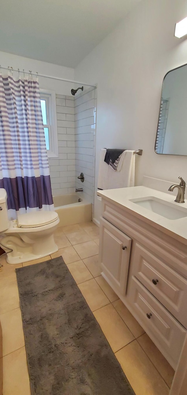 full bathroom featuring toilet, shower / bath combination with curtain, vanity, and tile patterned floors