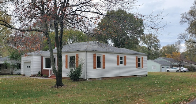 view of property exterior with a lawn and a garage