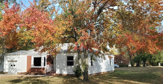 exterior space featuring a garage and a front yard