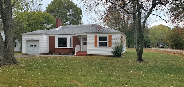 view of front of property with a garage and a front yard