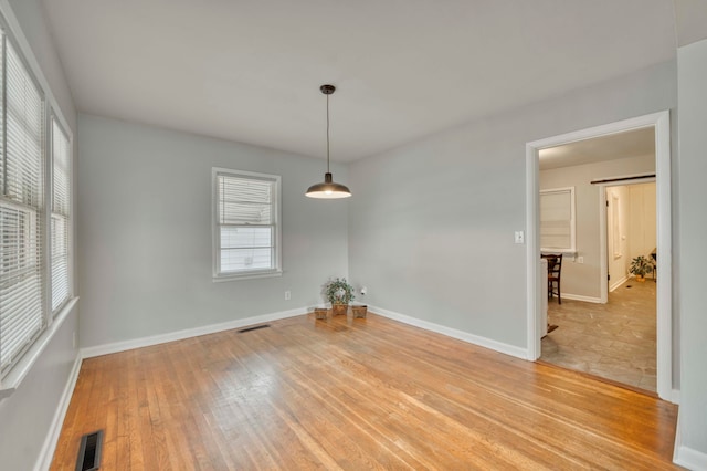 spare room featuring light hardwood / wood-style flooring