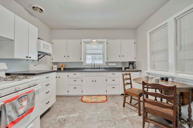 kitchen featuring white cabinets, white appliances, and sink