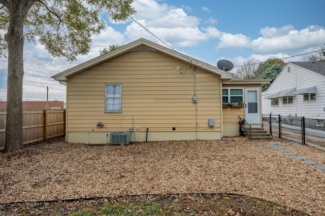 rear view of house featuring cooling unit