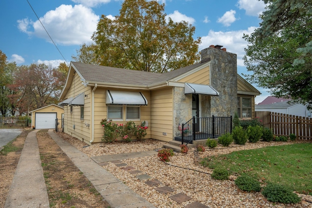 bungalow-style house featuring an outdoor structure and a garage