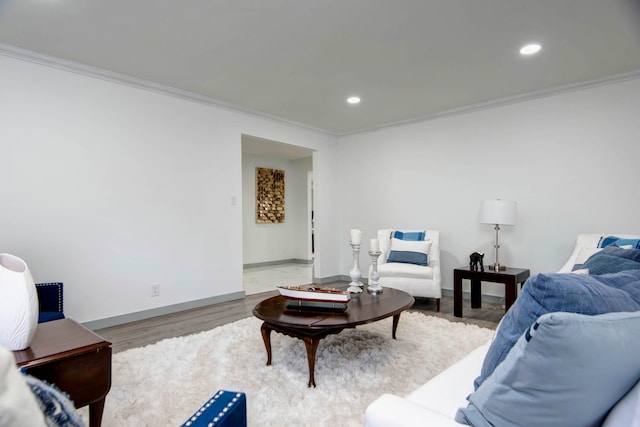 living room with light hardwood / wood-style floors and crown molding