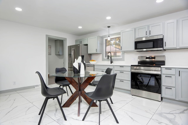 kitchen with decorative light fixtures and appliances with stainless steel finishes