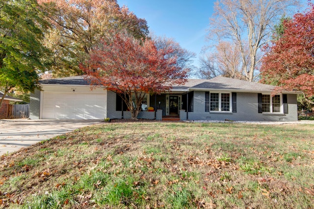 single story home with a front yard and a garage