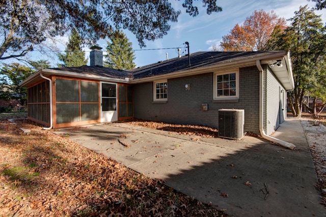 rear view of house featuring central AC, a sunroom, and a patio area