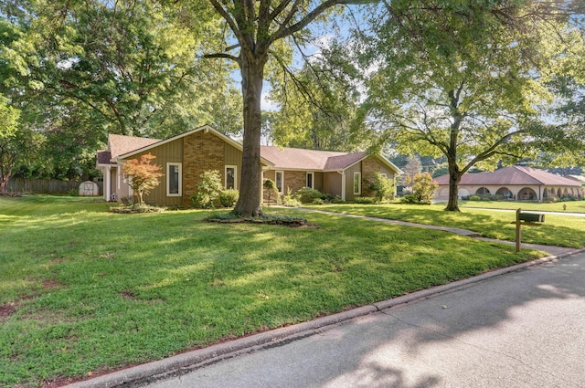 ranch-style home featuring a front yard