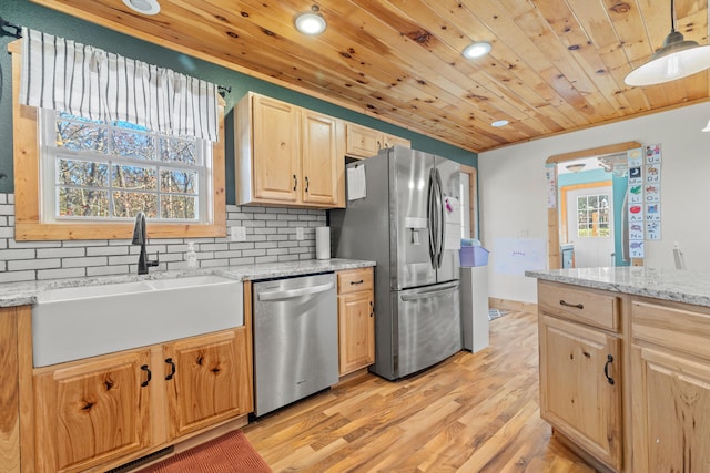 kitchen with sink, light hardwood / wood-style flooring, pendant lighting, light brown cabinetry, and appliances with stainless steel finishes