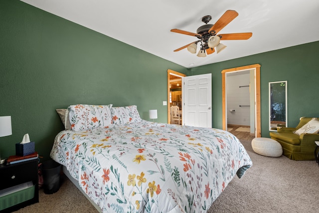 bedroom with carpet flooring, ceiling fan, and ensuite bathroom