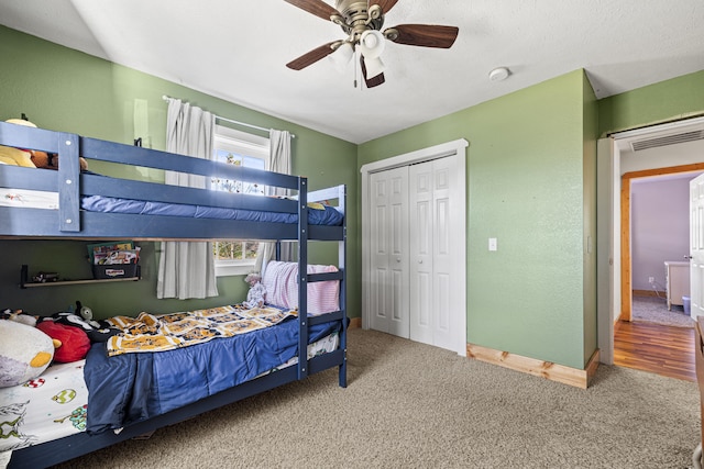 bedroom featuring ceiling fan, a closet, and carpet