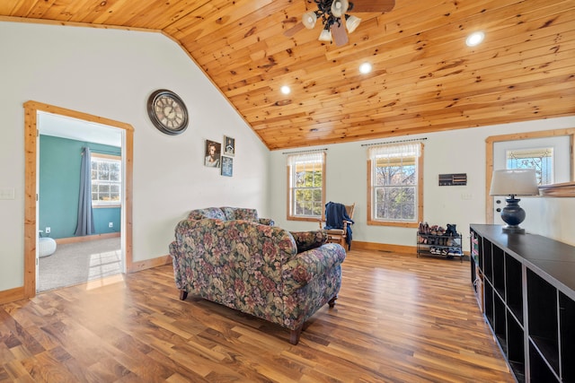 living room featuring hardwood / wood-style floors, vaulted ceiling, ceiling fan, and wooden ceiling