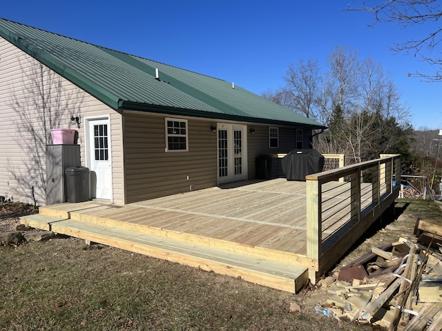 rear view of property featuring a wooden deck