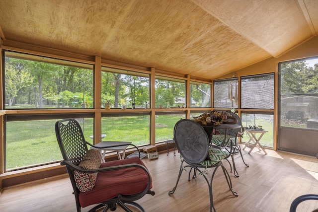 sunroom / solarium featuring a wealth of natural light, wood ceiling, and lofted ceiling