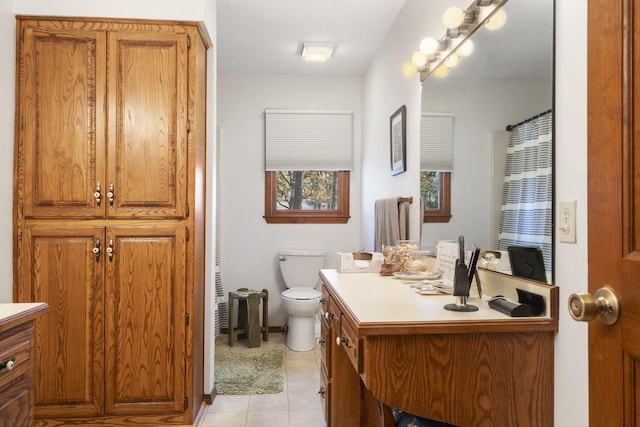 bathroom featuring toilet, vanity, and tile patterned floors