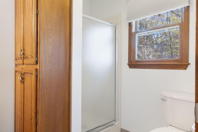 bathroom with toilet and walk in shower