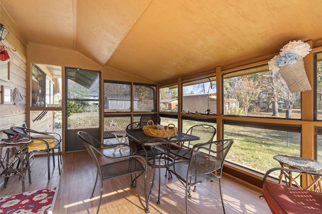 sunroom featuring a healthy amount of sunlight and vaulted ceiling