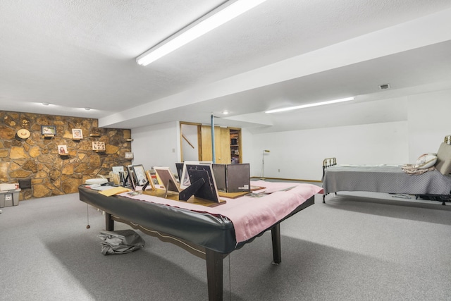 recreation room with carpet, a textured ceiling, and pool table