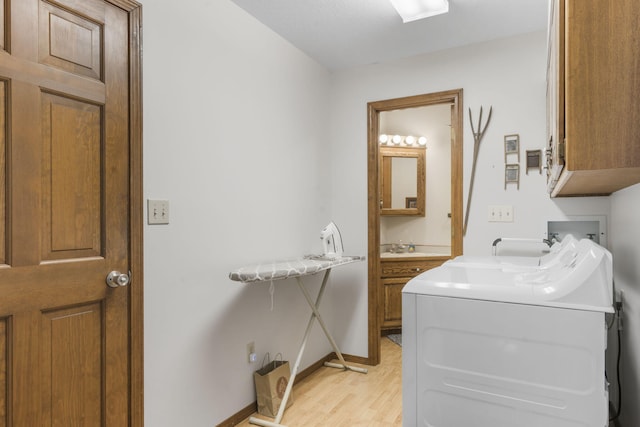 bathroom featuring wood-type flooring, vanity, and washer and clothes dryer