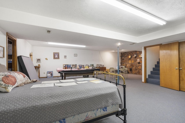 bedroom with carpet, a textured ceiling, and billiards