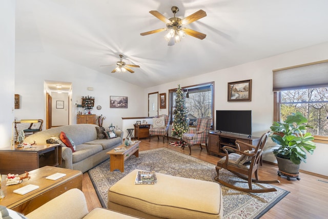 living room featuring ceiling fan, light hardwood / wood-style flooring, and lofted ceiling