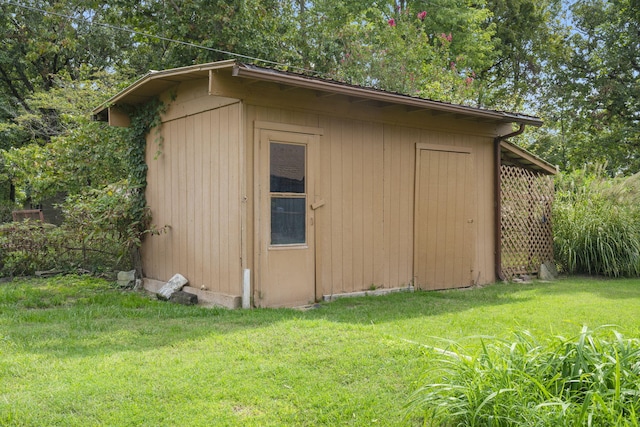 view of outbuilding featuring a yard