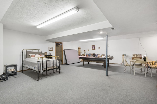 carpeted bedroom featuring a textured ceiling