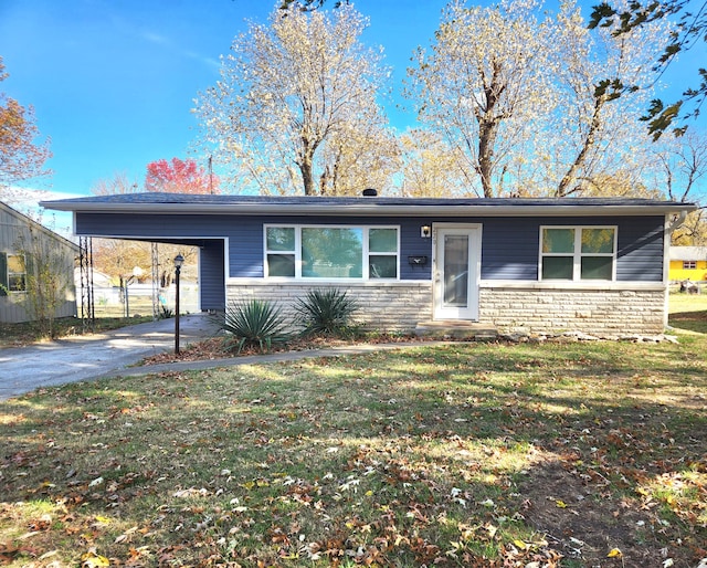 single story home with a front lawn and a carport