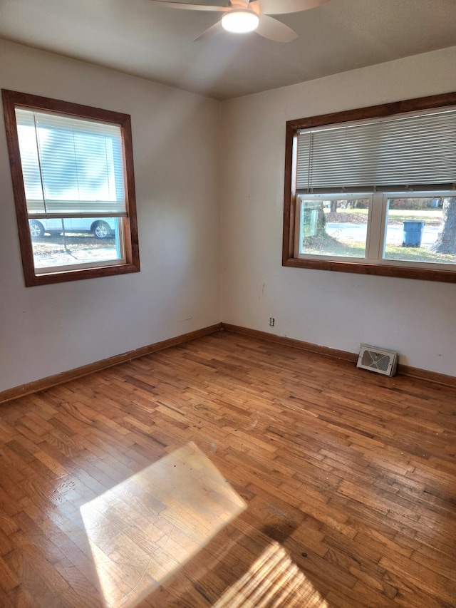 empty room featuring ceiling fan and light hardwood / wood-style flooring