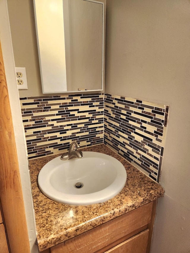 bathroom with vanity and backsplash